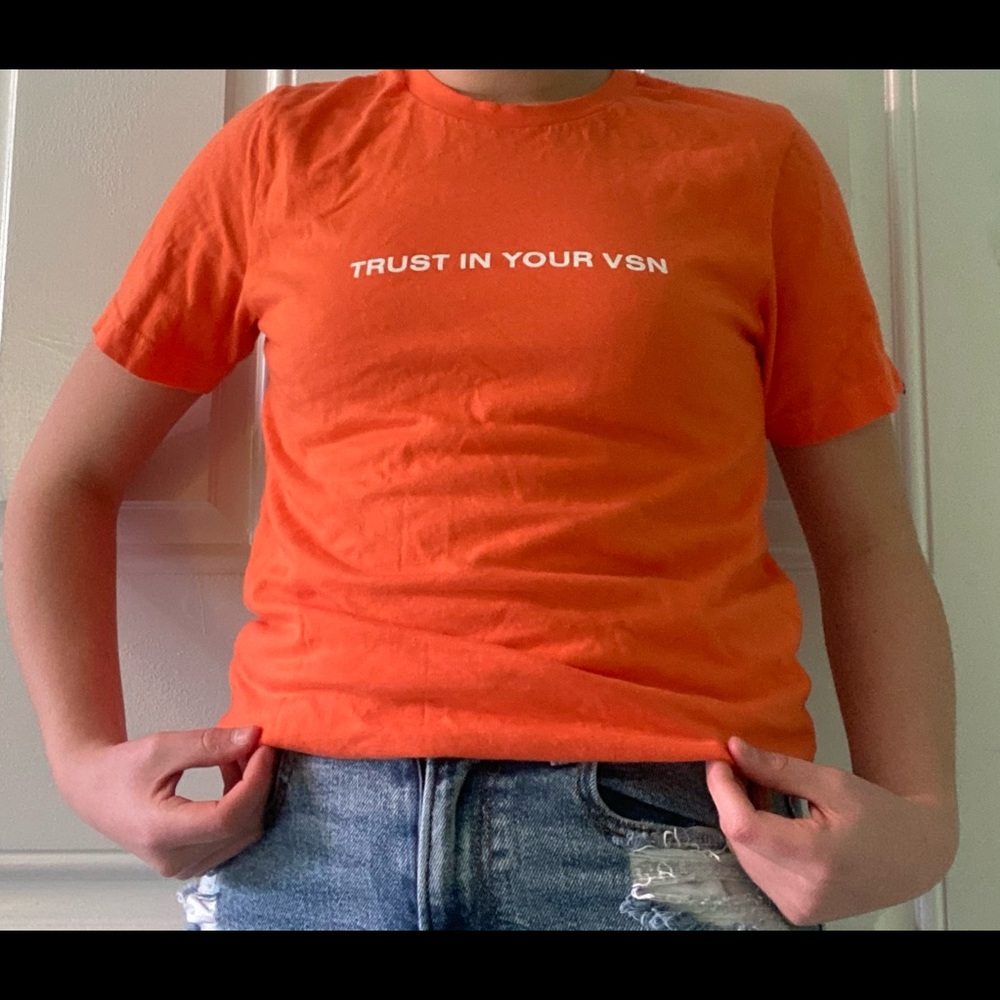 Worldinvision orange “Trust In Your Vision” tee